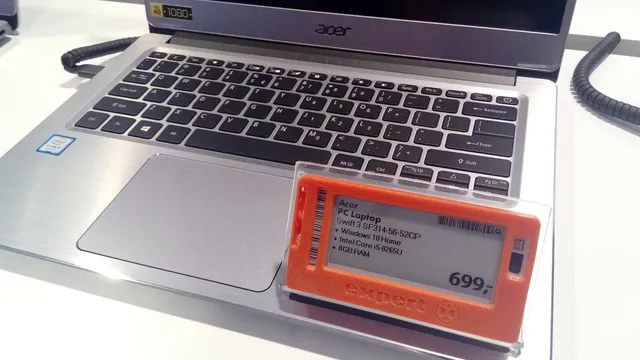 Portátil Acer prateado em exposição numa loja, com etiqueta eletrónica laranja que indica 8 GB de RAM e o preço de 699