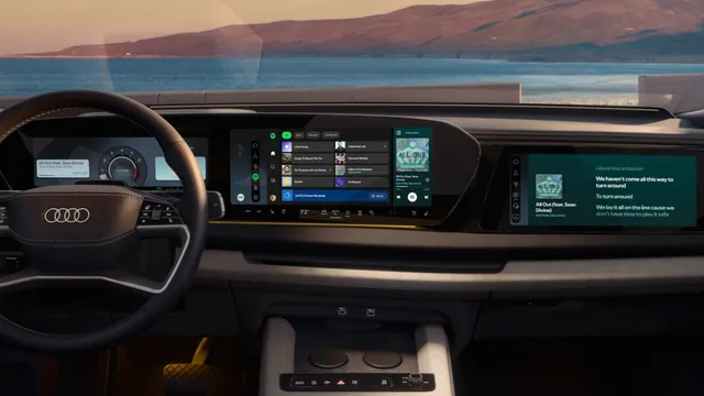 Interior de um Audi com a aplicação Spotify aberta no ecrã central do tablier e a letra de uma música no ecrã do passageiro