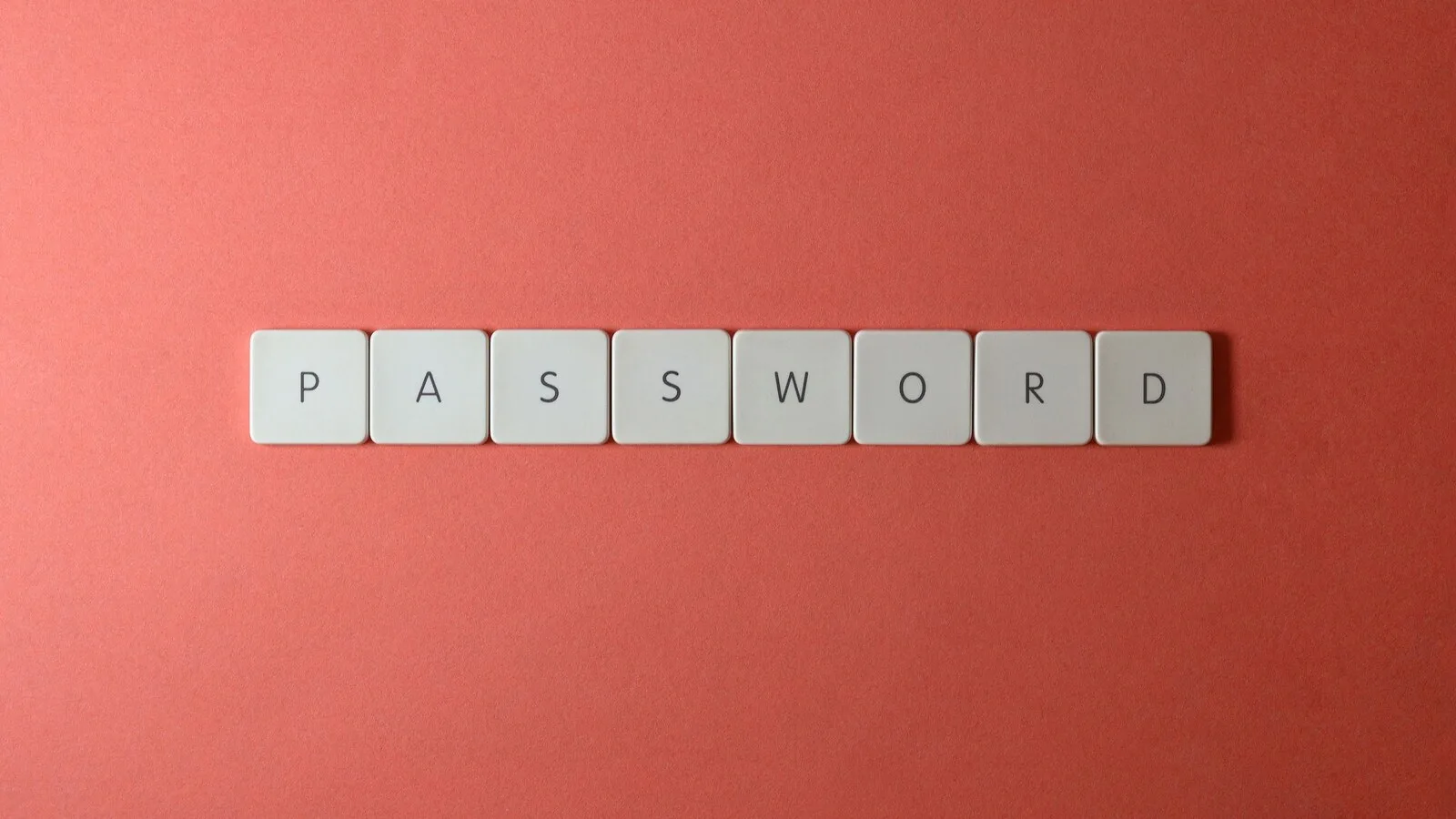 Peças de jogo de letras a formar a palavra password sobre um fundo vermelho