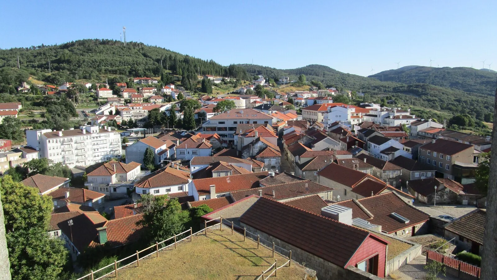 Vista da vila de Montalegre a partir das muralhas do castelo, com casas de telhados vermelhos e serra ao fundo